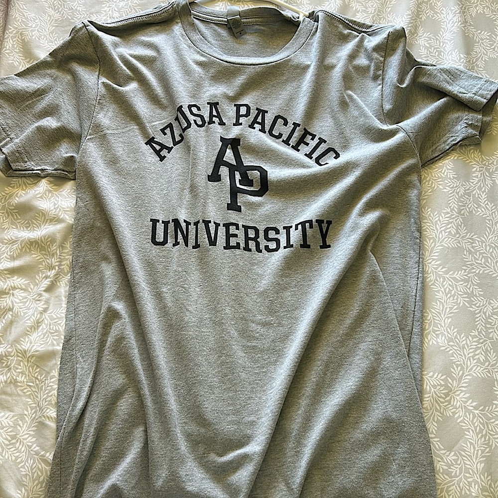 A medium sized shirt with the words, Azusa Pacific University on it.
